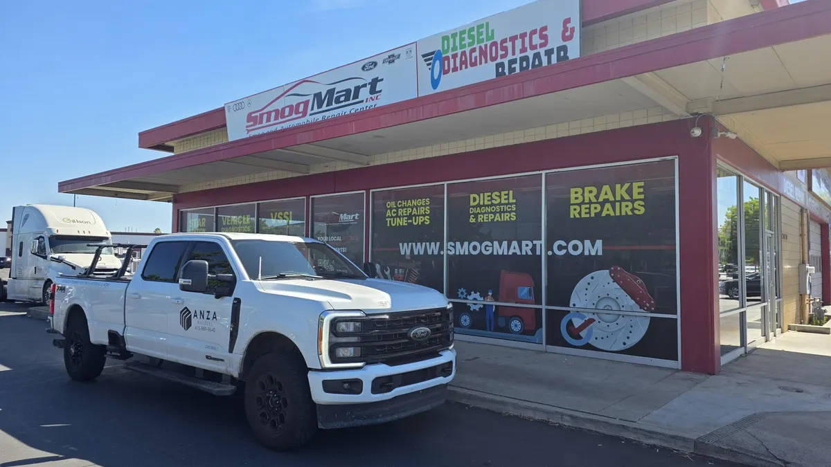 Diesel pickup pulling into Smog Mart for service