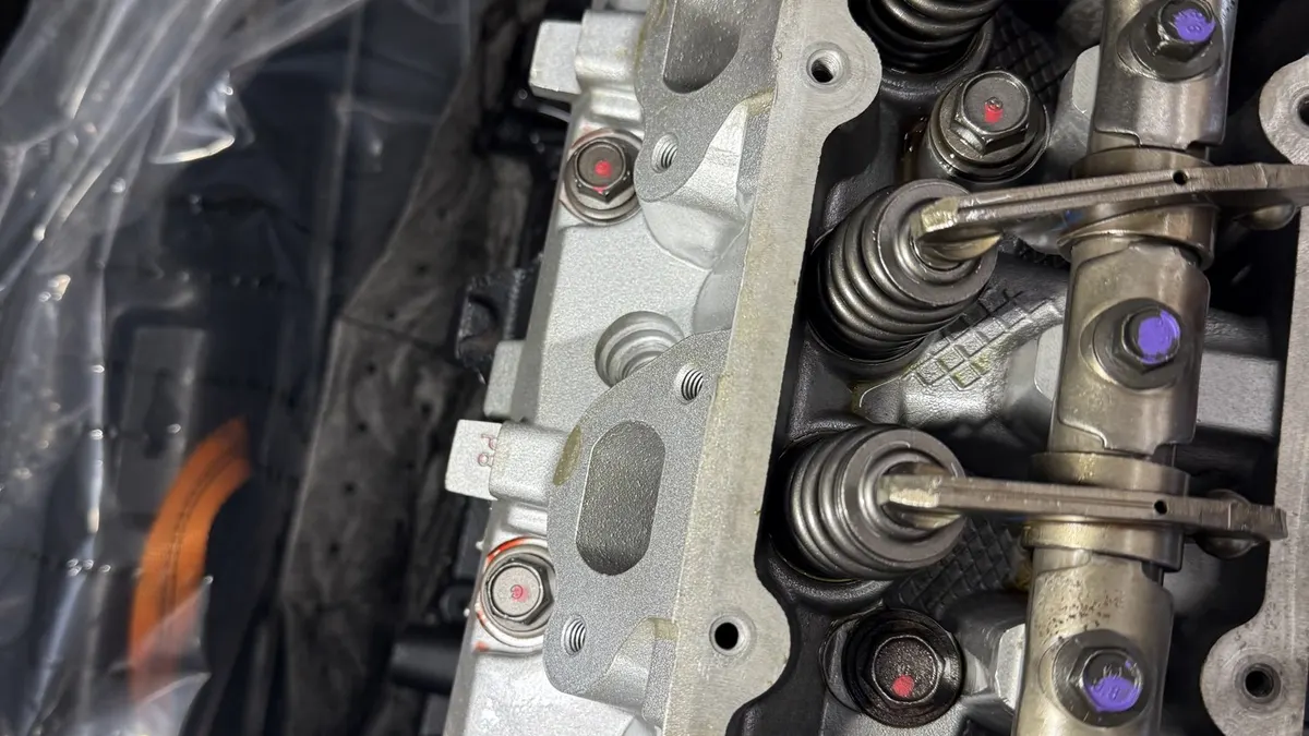 Cylinder head with valves during an engine rebuild at Smog Mart
