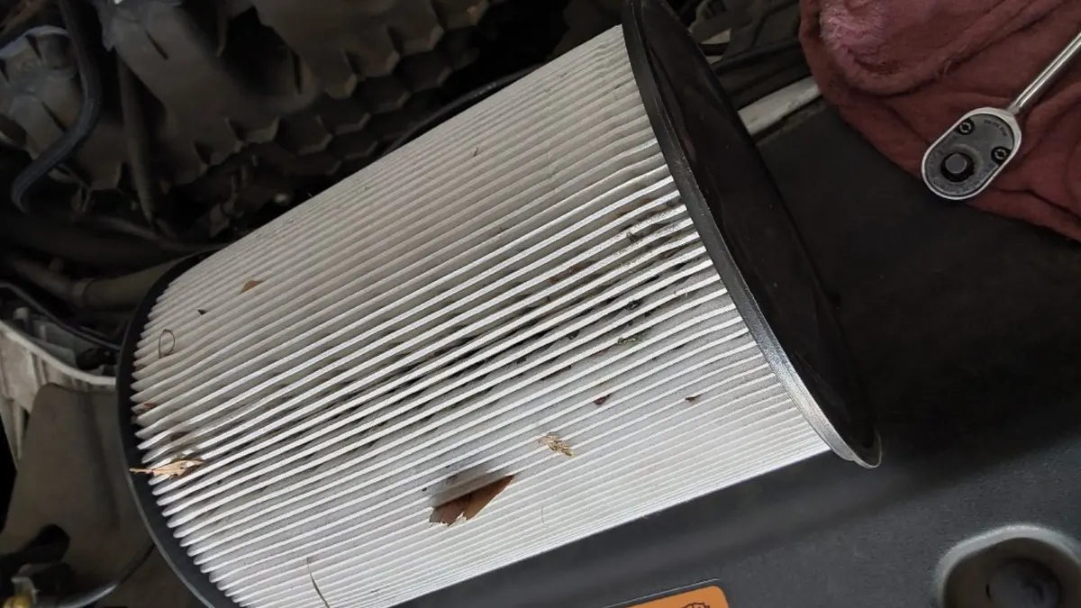 Engine air filter checked during an oil change at Smog Mart